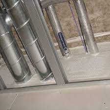 Fire batts and mastic sealing a service riser opening