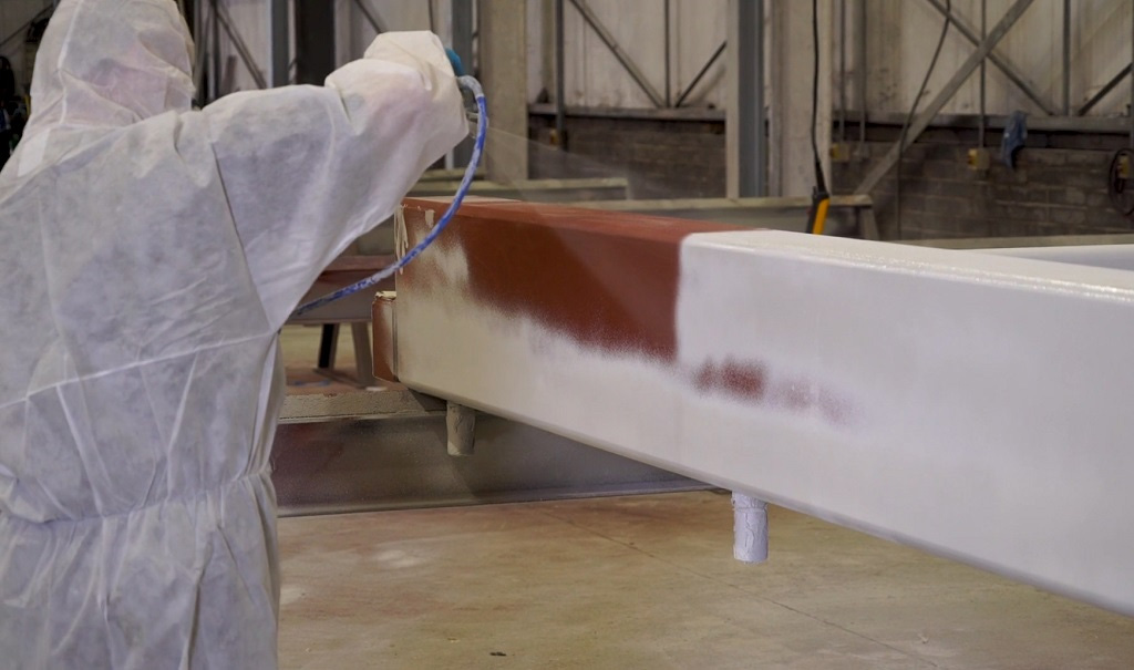 Shop-applied coating line with steel sections